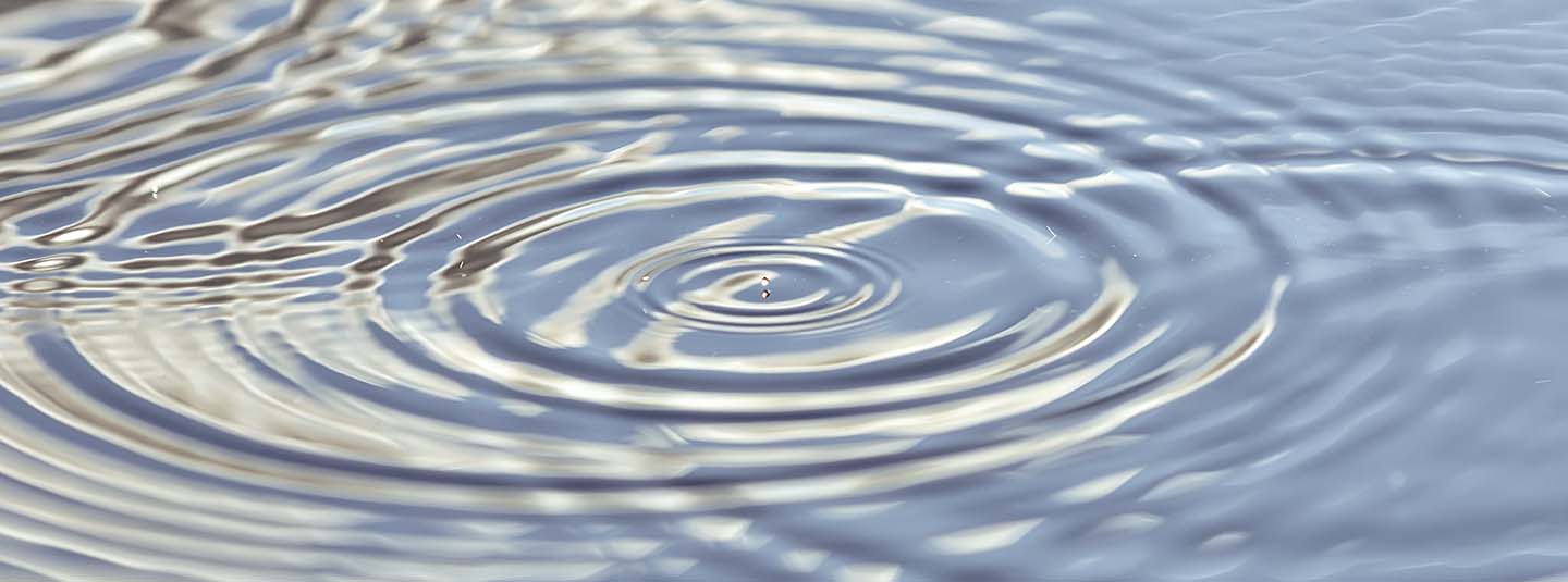 Closeup of concentric water ripple circles in fresh water